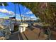 Boats docked in a marina, a waterfront walkway and a blue sky filled with fluffy clouds at 850 S Tamiami Trl # 307, Sarasota, FL 34236