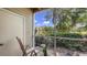 Relaxing screened-in lanai with views of the lush landscaping and pond at 850 S Tamiami Trl # 307, Sarasota, FL 34236