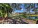 Scenic view of a pond with a fountain, surrounded by lush greenery and residential buildings at 850 S Tamiami Trl # 307, Sarasota, FL 34236