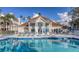 Community clubhouse with a pool and comfortable lounge chairs for relaxation at 850 S Tamiami Trl # 307, Sarasota, FL 34236