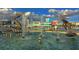 A fountain with dolphin statues in the foreground with city buildings, boats and blue sky at 850 S Tamiami Trl # 307, Sarasota, FL 34236