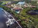 Scenic aerial view showcasing the marina, clubhouse, pool, and waterfront homes at 9441 Discovery Ter # 101A, Bradenton, FL 34212