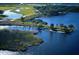 Breathtaking aerial view showcasing the community's lakes, lush greenery, and meticulously designed golf course at 9441 Discovery Ter # 101A, Bradenton, FL 34212