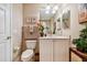 Cozy bathroom featuring a large mirror, tropical decor and neutral color palette at 9441 Discovery Ter # 101A, Bradenton, FL 34212