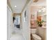 Bathroom and hallway with neutral walls, tile flooring, and decorative towels and flower arrangement at 9441 Discovery Ter # 101A, Bradenton, FL 34212