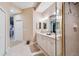 Bright bathroom with double vanity, white cabinets, and tile flooring, offers a clean design at 9441 Discovery Ter # 101A, Bradenton, FL 34212