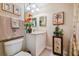 Bathroom featuring a vanity, mirror, toilet, tropical decor, and shower with curtain at 9441 Discovery Ter # 101A, Bradenton, FL 34212