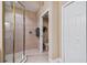 Bathroom featuring tiled walk-in shower with glass door and view of the toilet at 9441 Discovery Ter # 101A, Bradenton, FL 34212