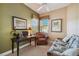 Bedroom featuring sleeper sofa, workstation, and ceiling fan at 9441 Discovery Ter # 101A, Bradenton, FL 34212
