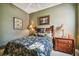 Comfortable bedroom featuring tropical themed bedding, light green walls, and natural light from the window at 9441 Discovery Ter # 101A, Bradenton, FL 34212