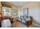 Bedroom featuring a sleeper sofa, leather armchair, and palm tree artwork at 9441 Discovery Ter # 101A, Bradenton, FL 34212