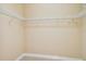 Walk-in closet featuring neutral carpet and walls, with shelving along the perimeter at 9441 Discovery Ter # 101A, Bradenton, FL 34212