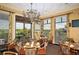 Elegant dining area with beautiful chandelier, large windows and outdoor access, perfect for fine dining experiences at 9441 Discovery Ter # 101A, Bradenton, FL 34212