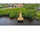Scenic aerial view of a wooden dock extending into the tranquil water at 9441 Discovery Ter # 101A, Bradenton, FL 34212