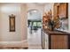 Charming entryway with a decorative cabinet, floral arrangement, and an arched doorway to the living area at 9441 Discovery Ter # 101A, Bradenton, FL 34212