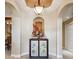Elegant entryway features a decorative cabinet with floral arrangements and recessed lighting at 9441 Discovery Ter # 101A, Bradenton, FL 34212