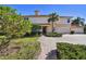 Beautiful home featuring a well-manicured lawn, a red brick driveway, and lush landscaping at 9441 Discovery Ter # 101A, Bradenton, FL 34212