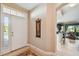 Welcoming foyer with a decorative rug and sidelight front door leading into a bright, open living space at 9441 Discovery Ter # 101A, Bradenton, FL 34212