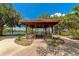 Charming wooden gazebo overlooking a serene lake, offering a peaceful spot for relaxation and contemplation at 9441 Discovery Ter # 101A, Bradenton, FL 34212