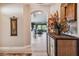 Hallway with tile floors leads to a living room that features large windows with natural light at 9441 Discovery Ter # 101A, Bradenton, FL 34212