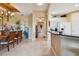 View from dining area of kitchen with white cabinets, granite countertops, and tile flooring at 9441 Discovery Ter # 101A, Bradenton, FL 34212