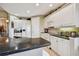 Functional kitchen featuring white cabinetry, dark countertops, and modern appliances for everyday cooking at 9441 Discovery Ter # 101A, Bradenton, FL 34212