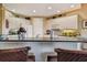 Kitchen bar with seating, granite countertops and white cabinetry at 9441 Discovery Ter # 101A, Bradenton, FL 34212
