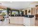 Well-lit kitchen with white cabinetry, dark granite counters, and open layout to dining and living spaces at 9441 Discovery Ter # 101A, Bradenton, FL 34212