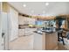 Bright kitchen with white cabinets, black countertops, an island, and a view to the living area at 9441 Discovery Ter # 101A, Bradenton, FL 34212