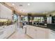 Open kitchen with white cabinets, granite countertops, and a view of the breakfast nook and water at 9441 Discovery Ter # 101A, Bradenton, FL 34212