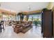 Relaxing living room with plush sofas, a cozy area rug, and expansive windows overlooking the lush landscape at 9441 Discovery Ter # 101A, Bradenton, FL 34212