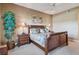 Comfortable main bedroom with a plush bed, tropical accents, and an abundance of natural light at 9441 Discovery Ter # 101A, Bradenton, FL 34212