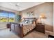Calm main bedroom boasts neutral tones, a plush bed with tropical bedding, and serene outdoor views at 9441 Discovery Ter # 101A, Bradenton, FL 34212
