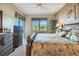 Bedroom with king bed, ceiling fan, large window, and a palm tree theme at 9441 Discovery Ter # 101A, Bradenton, FL 34212