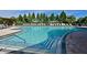 Resort-style pool with pristine water and comfortable lounge chairs for relaxation and leisure at 9441 Discovery Ter # 101A, Bradenton, FL 34212
