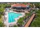 View of the community pool alongside the clubhouse and a wooden footbridge at 9441 Discovery Ter # 101A, Bradenton, FL 34212
