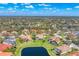 Panoramic aerial view of a beautiful community featuring tile-roofed homes and serene lakes under a sunny sky at 9612 Old Hyde Park Pl, Bradenton, FL 34202