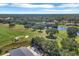 Overhead view of a golf course with rolling fairways, mature trees, water features, and adjacent homes at 9612 Old Hyde Park Pl, Bradenton, FL 34202