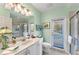 Well lit bathroom offering neutral tile, double sinks, and a walk-in shower at 9612 Old Hyde Park Pl, Bradenton, FL 34202