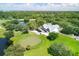 Aerial shot of the golf clubhouse, with putting green and lush trees surrounding the building at 9612 Old Hyde Park Pl, Bradenton, FL 34202
