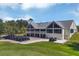 View of clubhouse overlooking the golf course, featuring numerous golf carts and a putting green at 9612 Old Hyde Park Pl, Bradenton, FL 34202