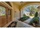 Inviting front porch with double doors, decorative rug, and lush landscaping framing the entrance at 9612 Old Hyde Park Pl, Bradenton, FL 34202