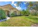Charming home with a well-manicured lawn, lush landscaping, and elegant architectural details at 9612 Old Hyde Park Pl, Bradenton, FL 34202