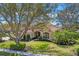 Beautiful home featuring a meticulously maintained lawn, mature landscaping, and a classic tile roof at 9612 Old Hyde Park Pl, Bradenton, FL 34202
