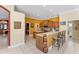 Bright kitchen with wooden cabinets, an island, and breakfast bar, perfect for casual dining and entertaining at 9612 Old Hyde Park Pl, Bradenton, FL 34202