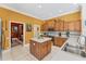 Traditional kitchen with wooden cabinetry, center island, and stainless steel appliances at 9612 Old Hyde Park Pl, Bradenton, FL 34202