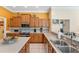 Bright kitchen featuring wood cabinets, tile backsplash, and stainless steel appliances at 9612 Old Hyde Park Pl, Bradenton, FL 34202