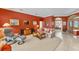 Comfortable living room with a plush sofa, accent chair, and a view into the adjacent office space at 9612 Old Hyde Park Pl, Bradenton, FL 34202
