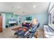 Bright living room featuring a large window, carpeted floor, and ceiling fans at 9612 Old Hyde Park Pl, Bradenton, FL 34202