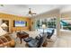 Spacious living room with a ceiling fan and sliding glass doors leading to the pool area at 9612 Old Hyde Park Pl, Bradenton, FL 34202